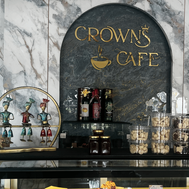 The Crown Cafe display of cakes, cookies and bottled coffee beneath the gold sign