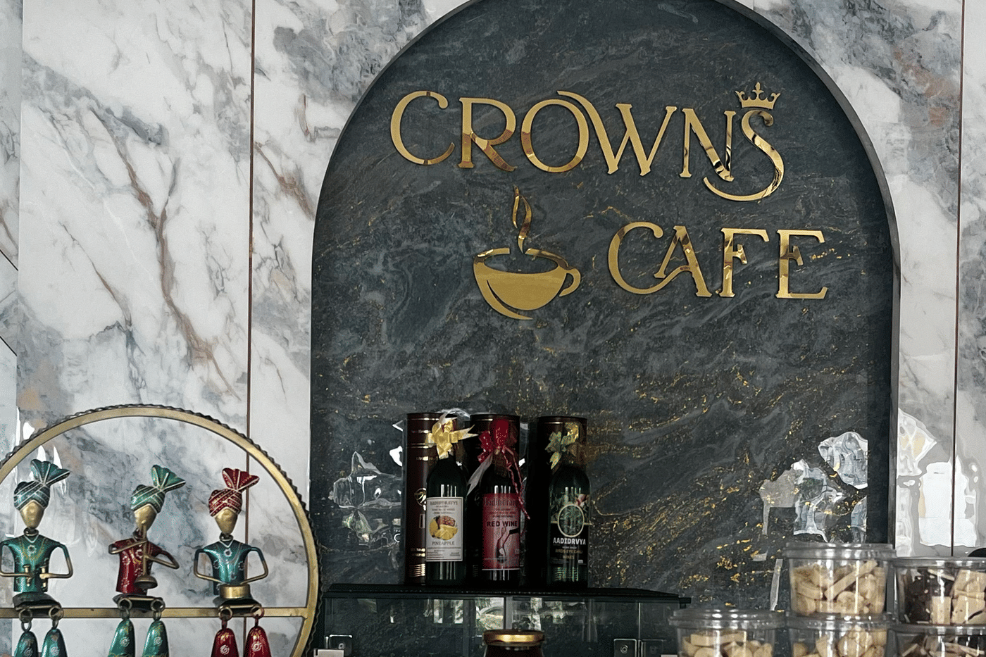 The Crown Cafe counter, with cakes, cookies and coffee beneath the gold sign