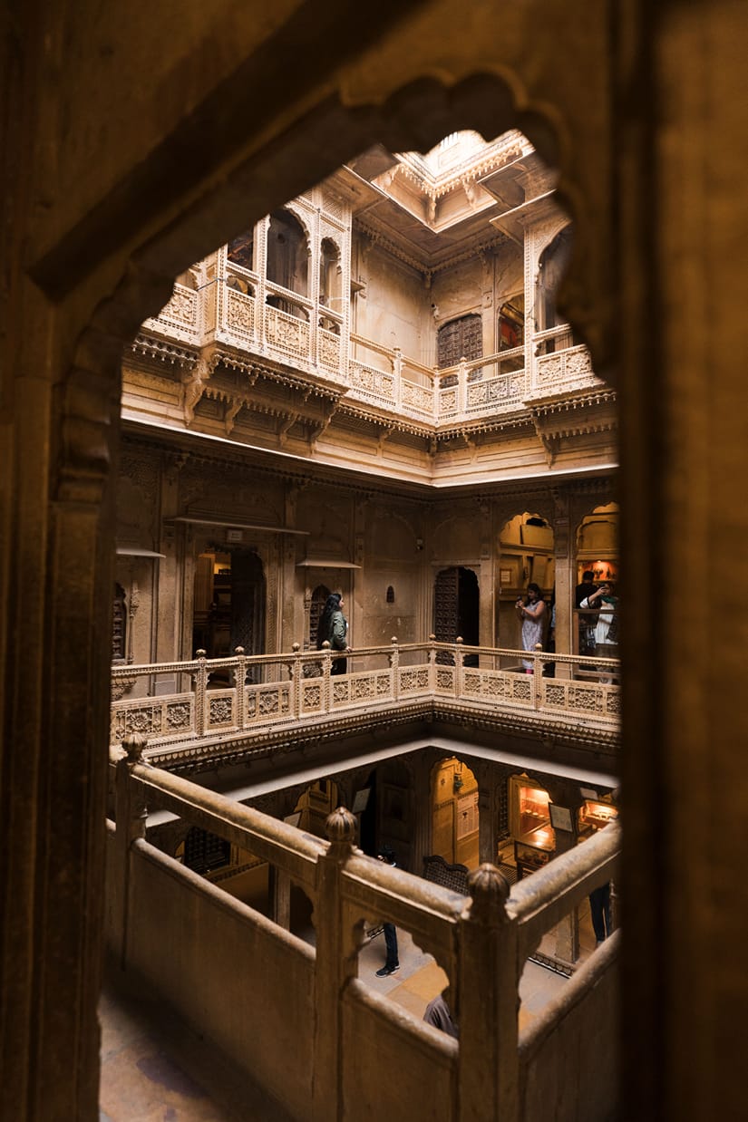 Stone arches looking into a multi-tiered courtyard inside Bagore Ki Haveli