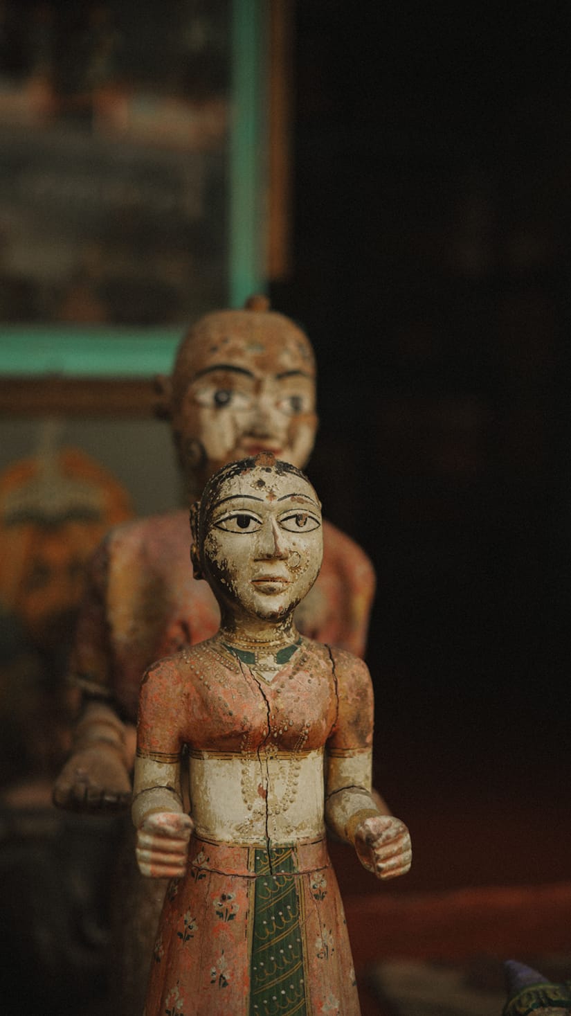 Carved wooden puppets representing a male and female figure displayed