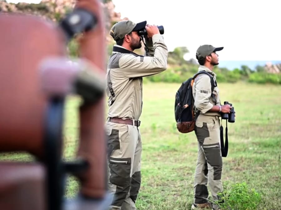 Two naturalists out with binoculars and camera
