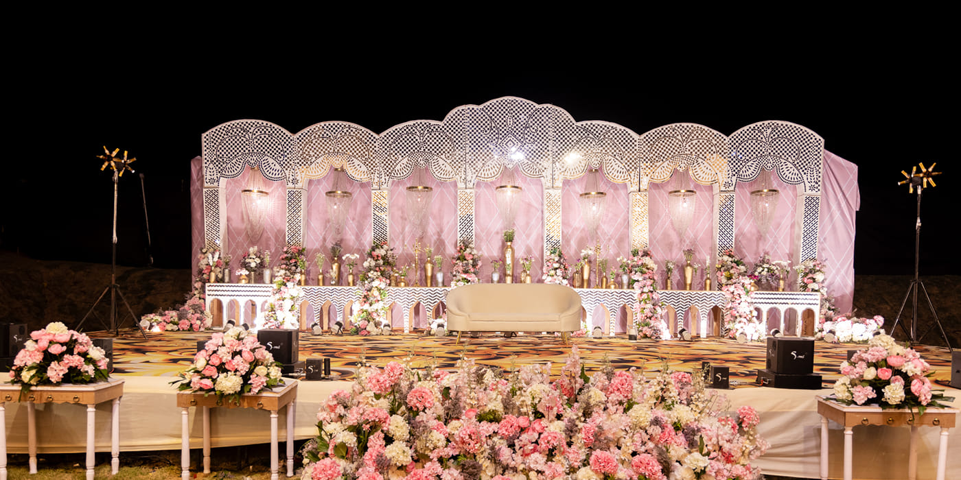 Wedding stage with floral decor at The Qualia Resort Club and Brewery, Udaipur