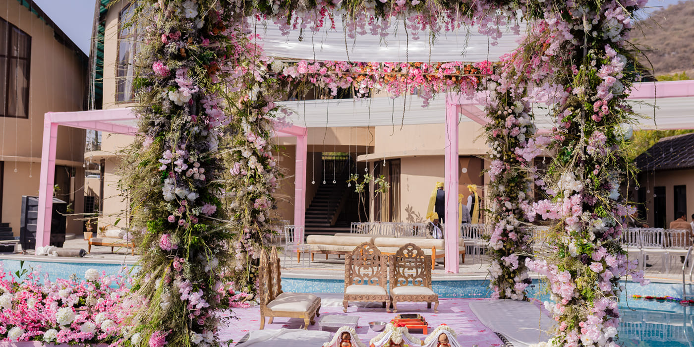 Floral wedding mandap at the poolside, The Qualia Resort Club and Brewery, Udaipur