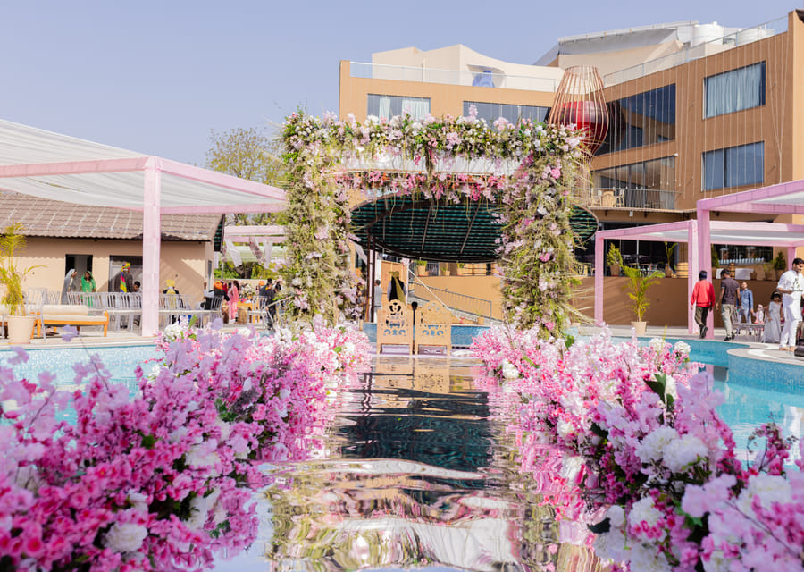 Poolside celebration and wedding setup at The Qualia Resort, Udaipur