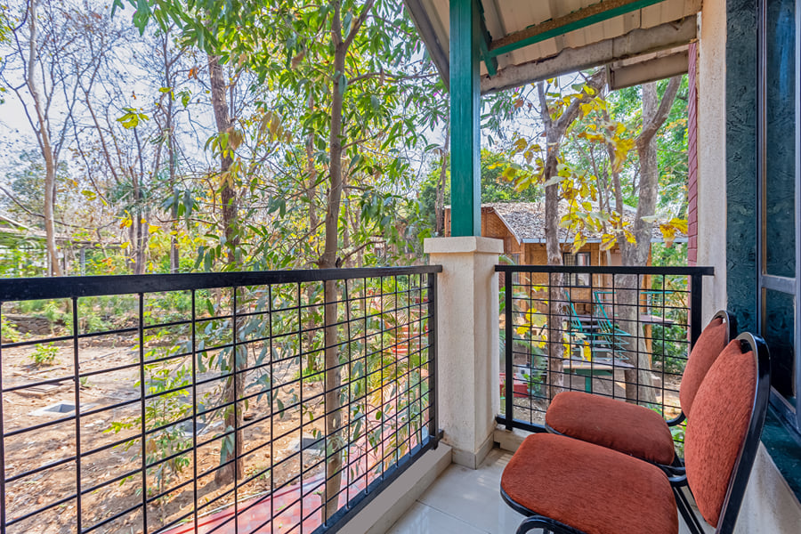 Garden Classic Room balcony at Nature Trails Sajan, looking into the trees