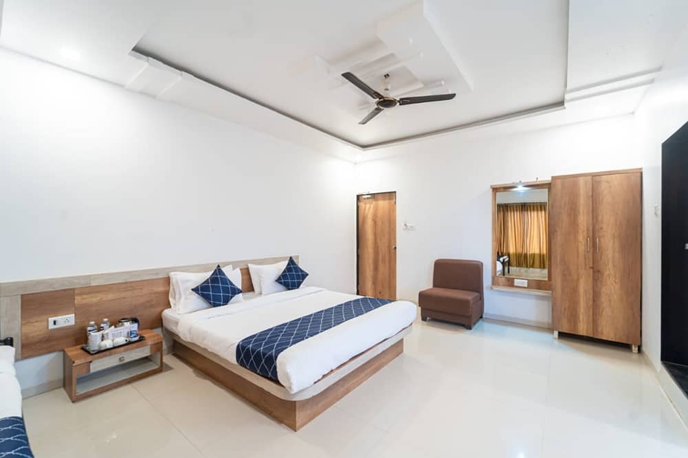 Penthouse Family Pool Corner Room with a king bed, a nightstand, a chair and a wardrobe