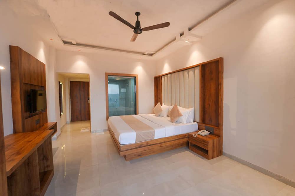 Premium Room with a king bed, side tables, a wooden work desk and a wardrobe