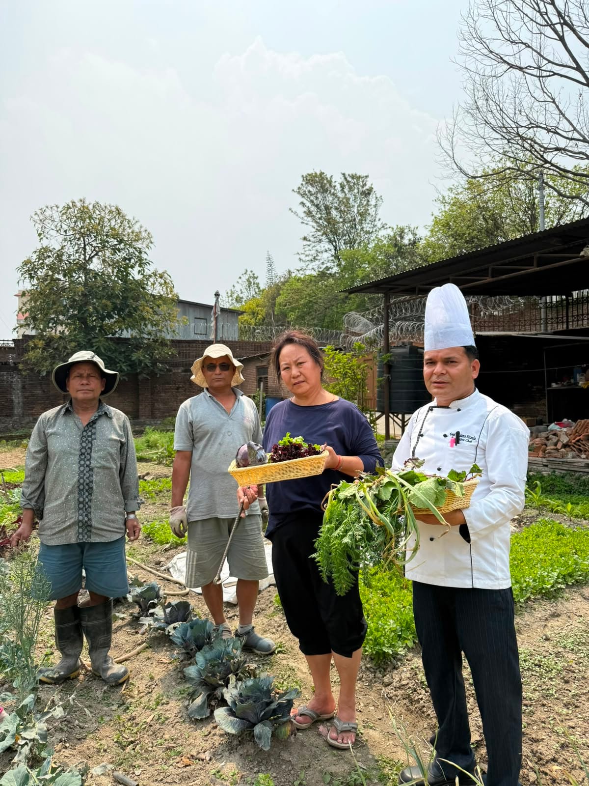 The chef and gardeners together on the organic farm at Nepali Ghar Hotel