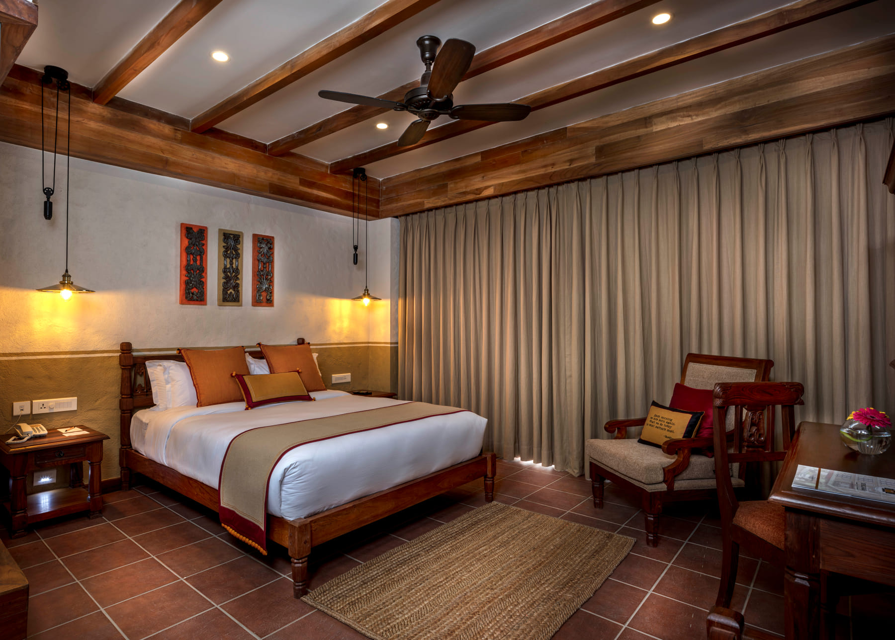 Heritage Deluxe Room with timber-beamed ceiling and hand-carved double bed