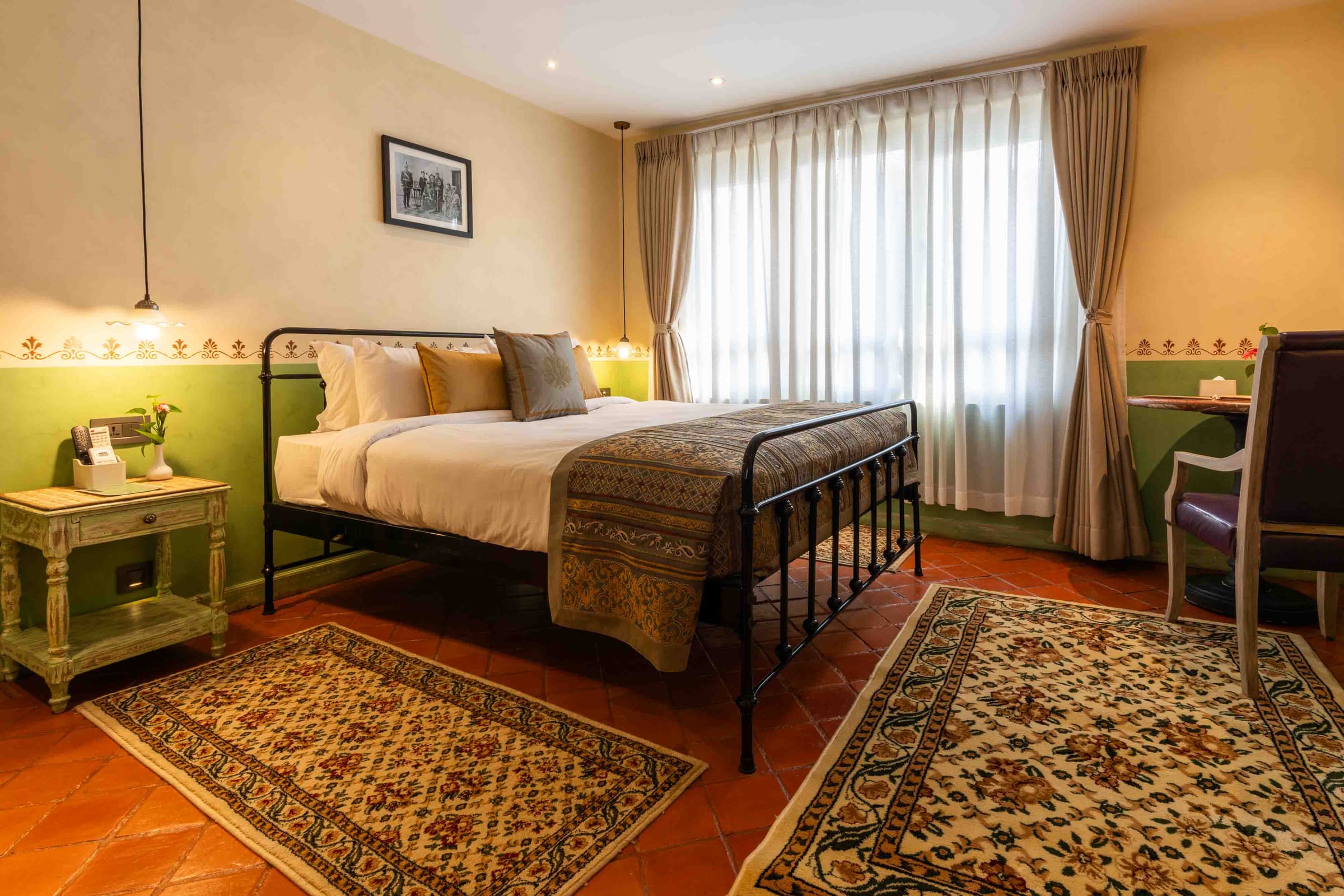 Classic Deluxe Room with period decor and a wrought-iron bed