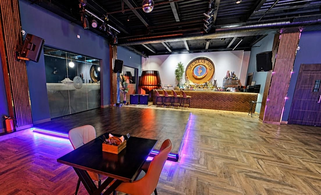 The bar counter and lounge seating at Secrets Sips
