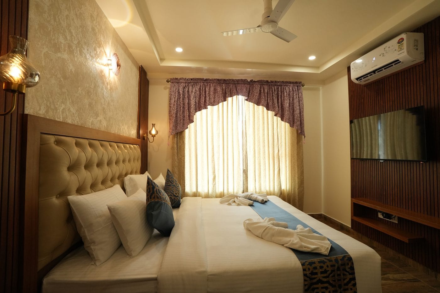 Classic Room with a king-size bed, a tall curtained window and a wall-mounted television