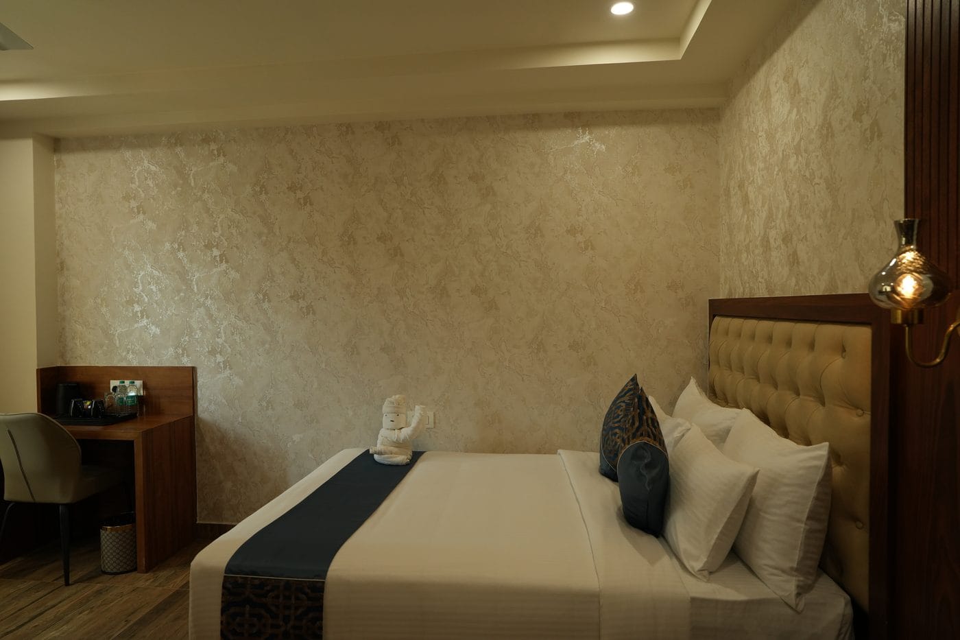 Classic Room work desk with an electric kettle and complimentary bottled water beside the bed