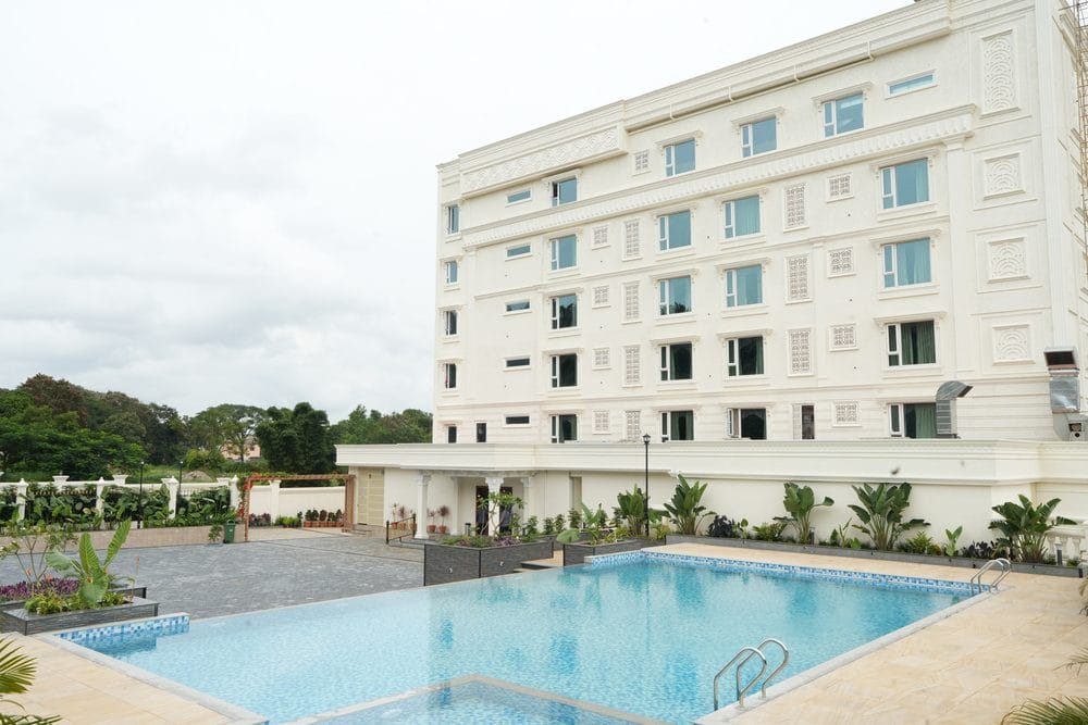 The swimming pool and paved deck, with the rear elevation of Captains Crown and planted borders beyond