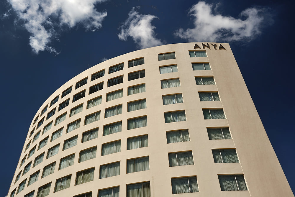The crescent facade of The Anya Hotel, Gurugram on Golf Course Road