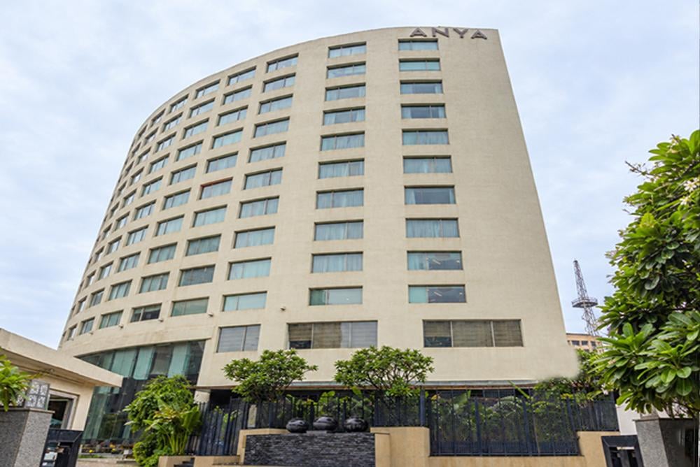 The crescent facade of The Anya Hotel on Golf Course Road, Gurugram