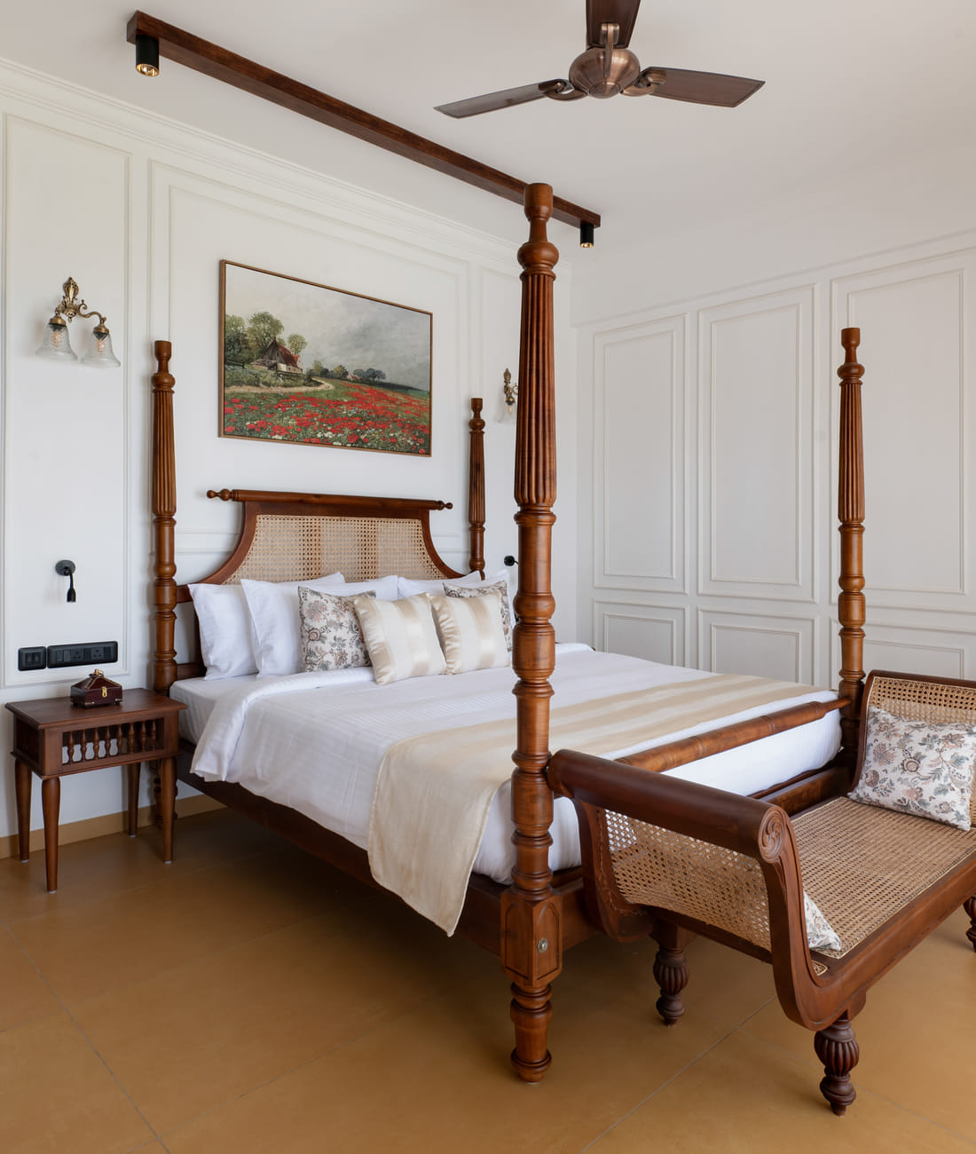 Heritage Suite four-poster king bed with cane headboard and a large poppy-field wall painting, Sanskreti