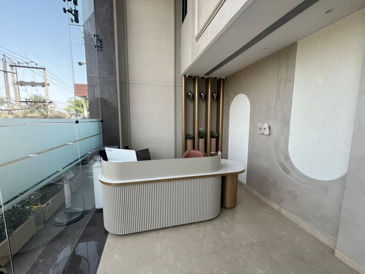 The terrace counter at Amara Portico, its fluted face and gold posts standing behind a glass balustrade above the street