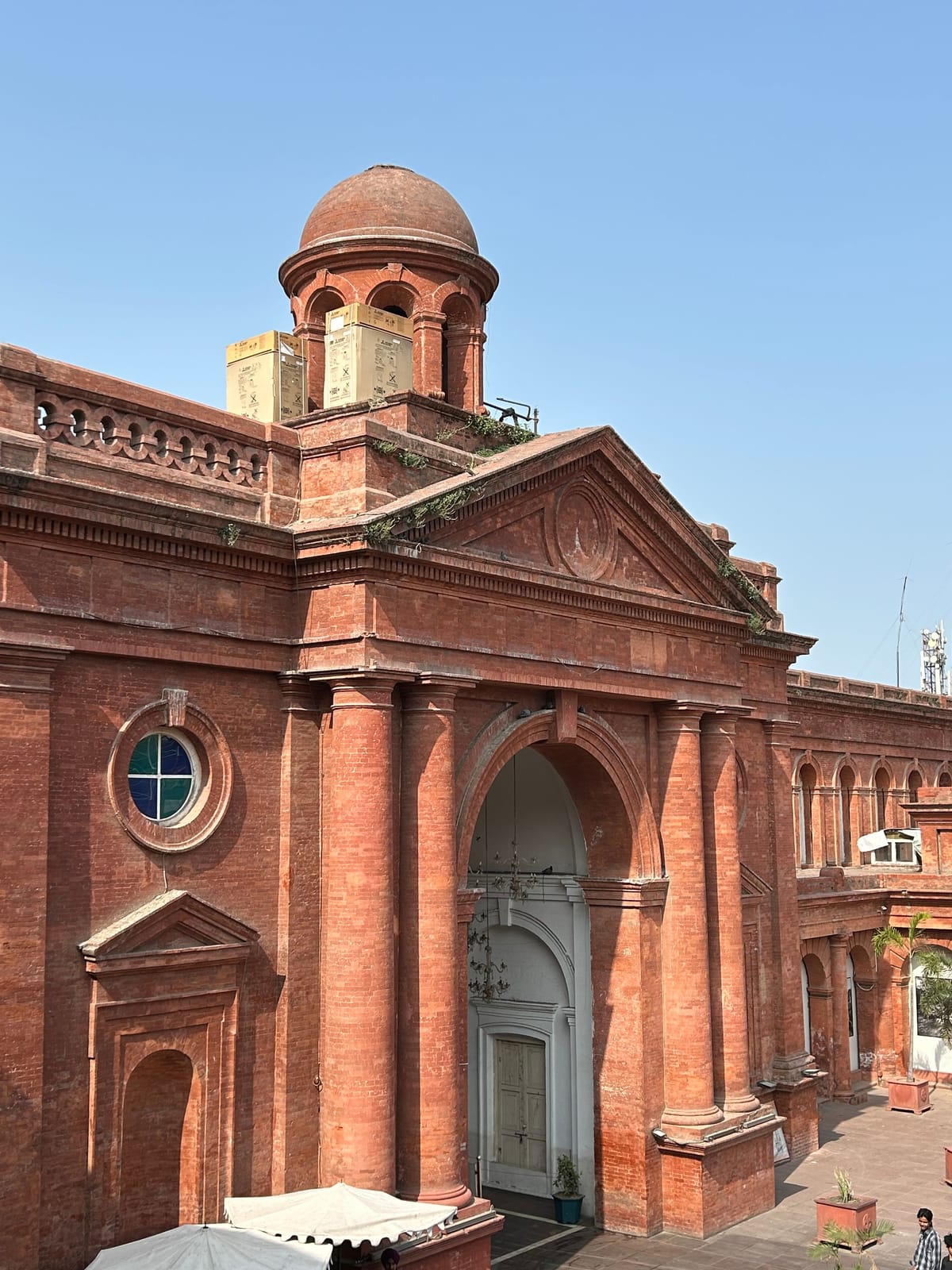 A red-brick colonial-era building in Amritsar with an arched entrance and a domed turret, among the landmarks near the hotel