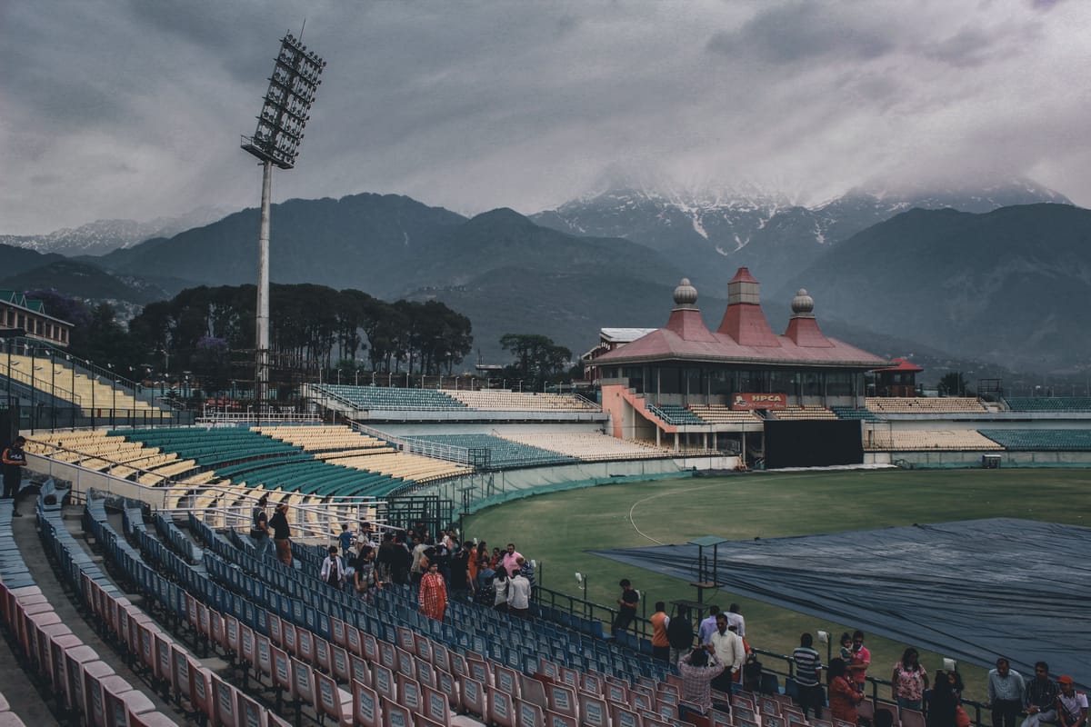 The HPCA cricket stadium at Dharamshala, its stands and pavilion set below the snow-capped Dhauladhar range rising behind