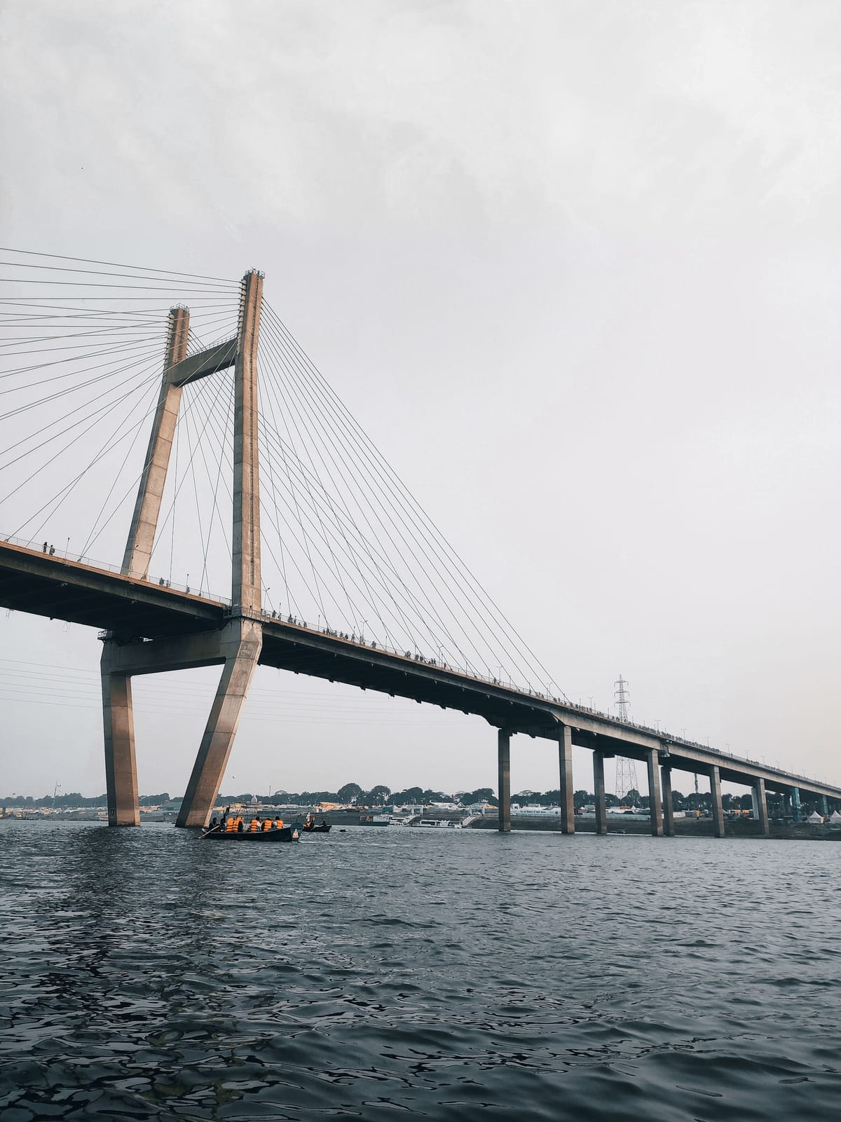 A cable-stayed bridge carrying the road across the water at Dwarka, its pylon rising above the span in the morning light