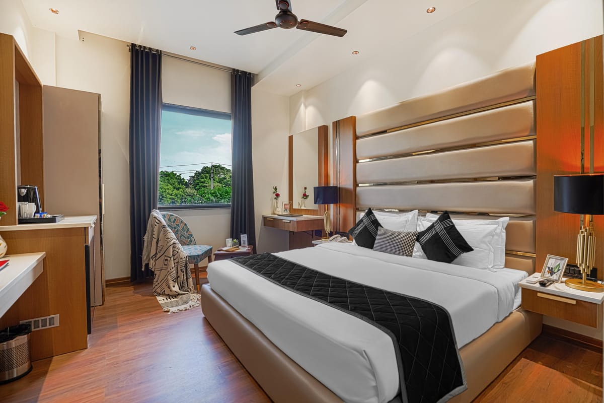 A Deluxe room at Aura Bliss, with a fluted headboard, bedside tables either side of the bed