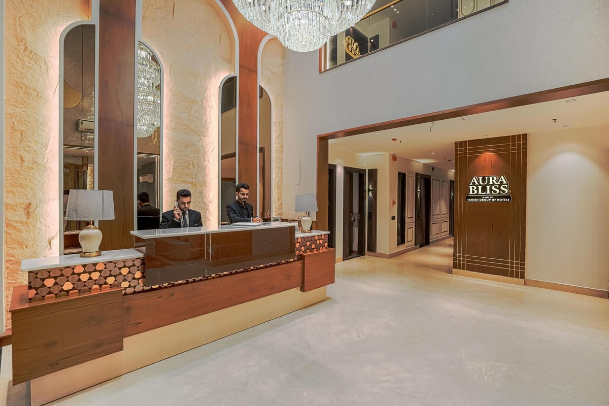 The reception at Aura Bliss, with two members of staff at the timber desk