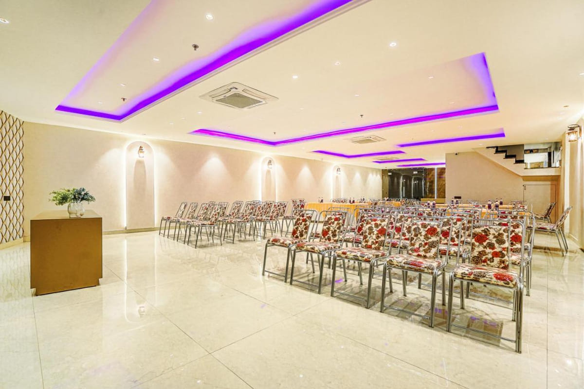 The banquet hall at Grand Cabbana laid out in rows of floral-patterned chairs for a conference, under a ceiling edged