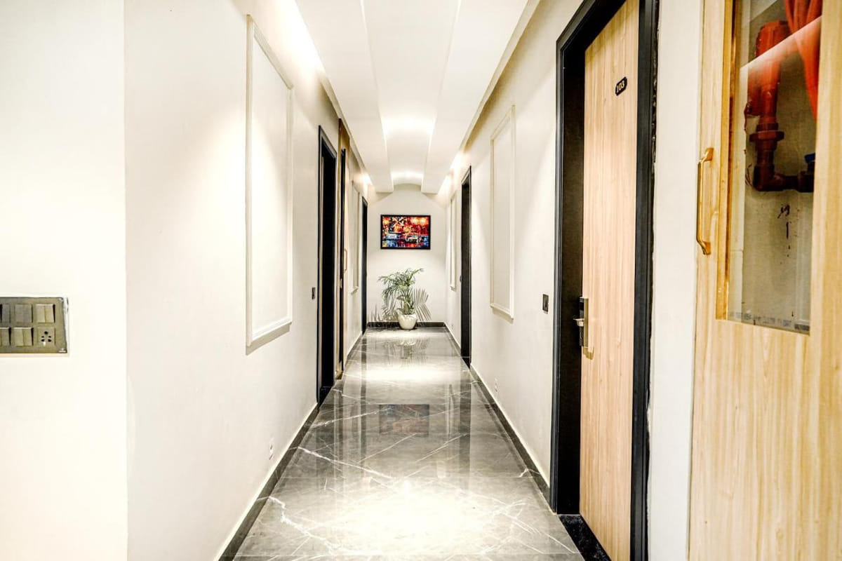 A guest room corridor at Grand Cabbana, with dark timber doors along a polished marble floor