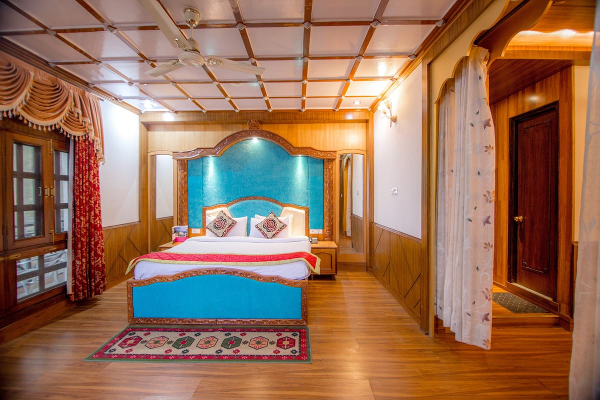 The Maharani Suite at Hotel Karnika, with a carved blue headboard