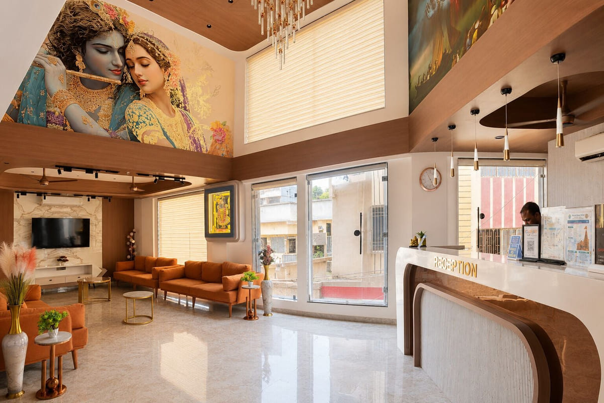 The reception at Hotel Shree Radhe By White Panda, with a member of staff at the curved counter