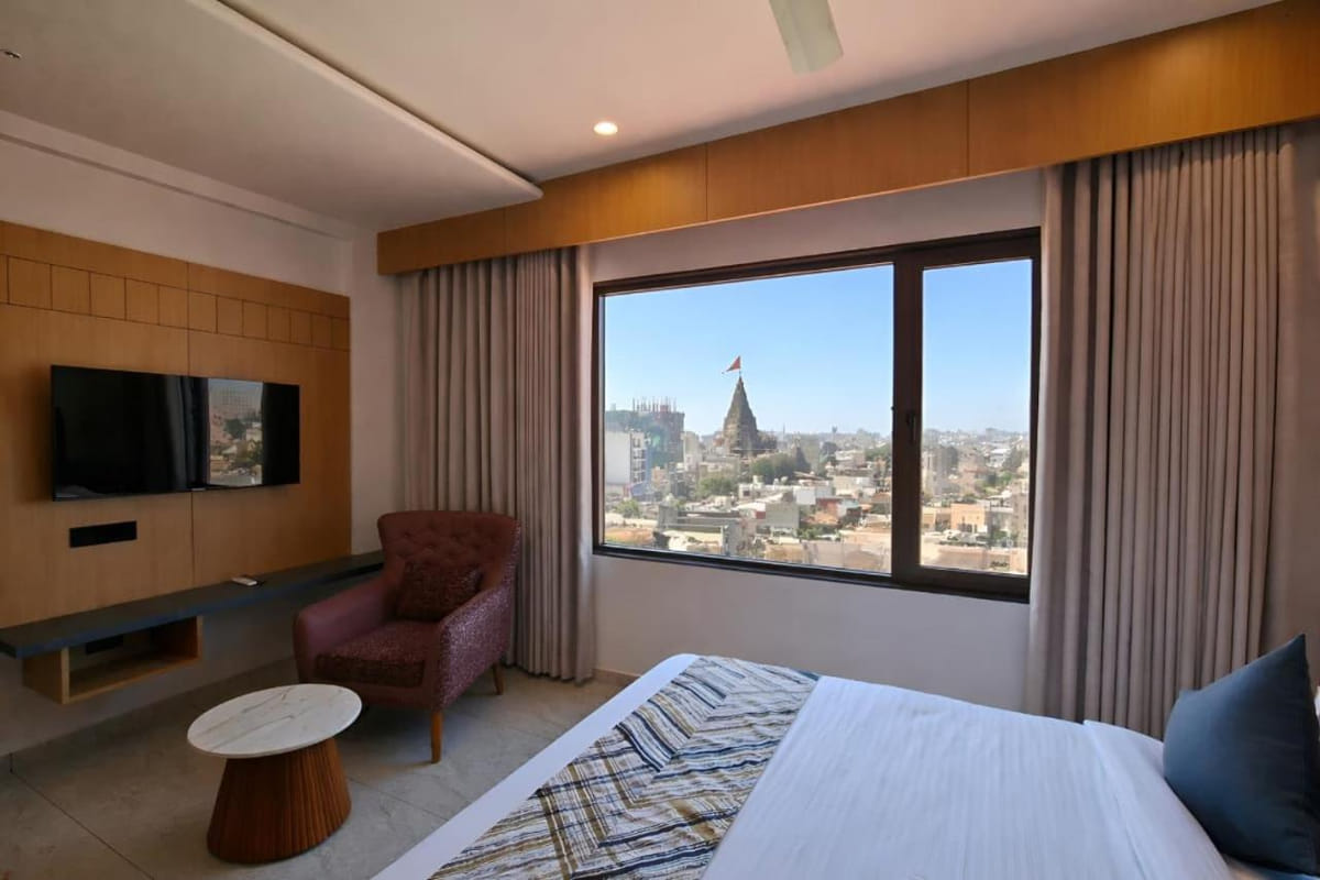A Temple and Sea View room at Hotel Shree Radhe By White Panda, with a television on the timber panel