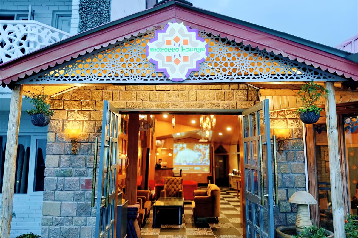 The stone-fronted restaurant and bar building at Levelup The Heritage Kud, its pitched roof and signage above the glass doors