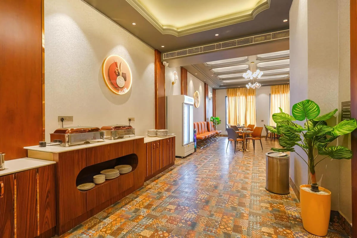 The breakfast buffet counter at Marrion Hotel, with chafing dishes along the wood-panelled counter, stacked plates