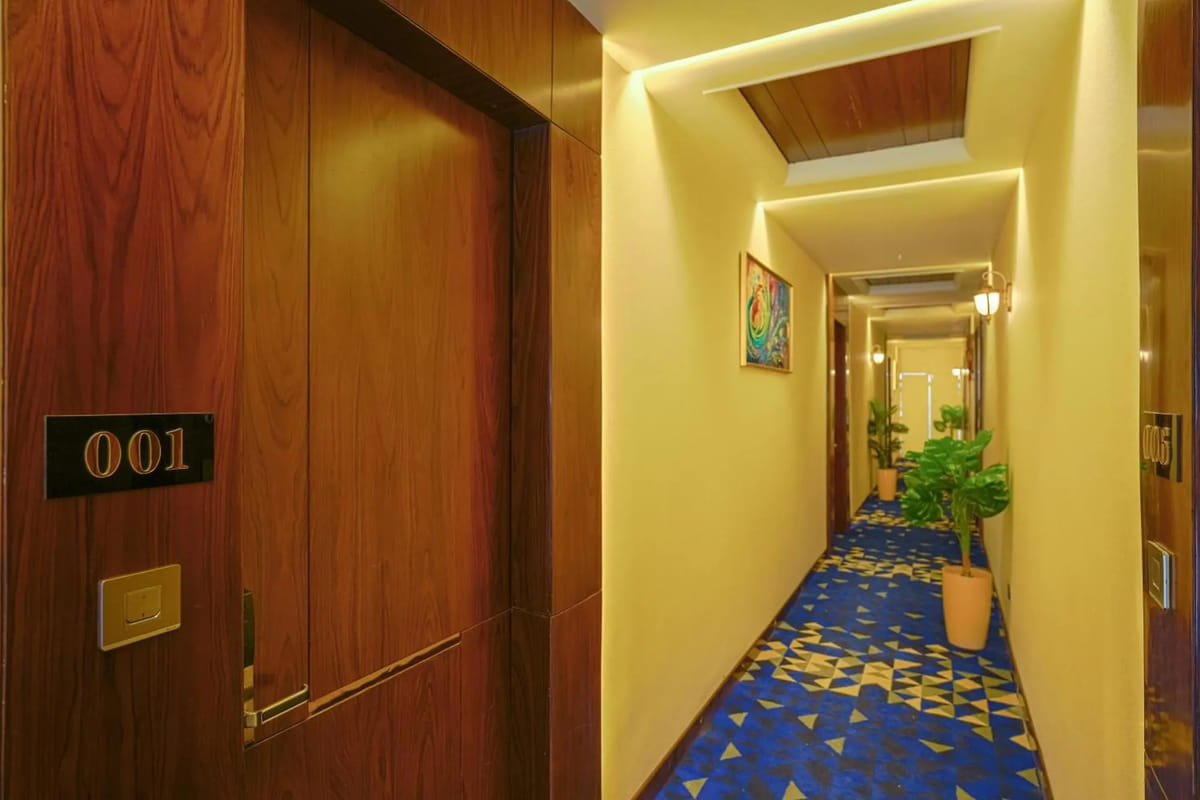 A guest room corridor at Marrion Hotel, with blue patterned carpet