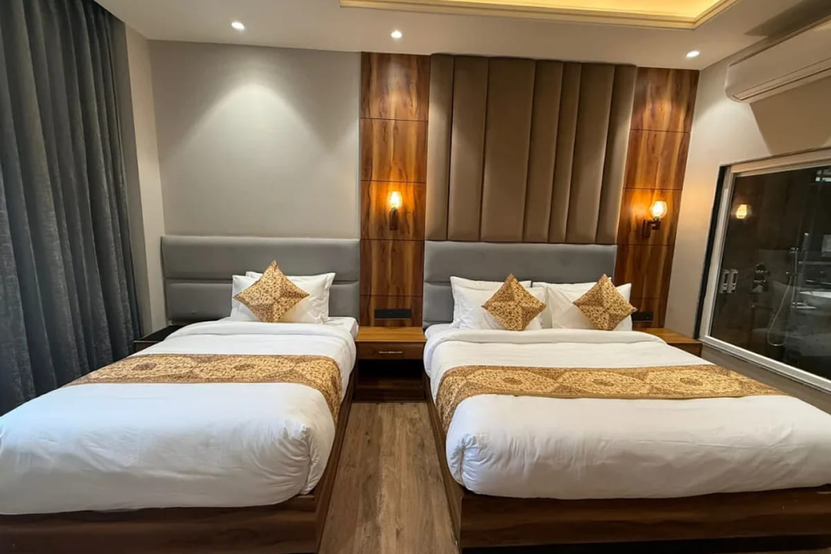 The Double Room Twin with City View at White Panda Hotel Divine Peaks, with two single beds against grey padded headboards