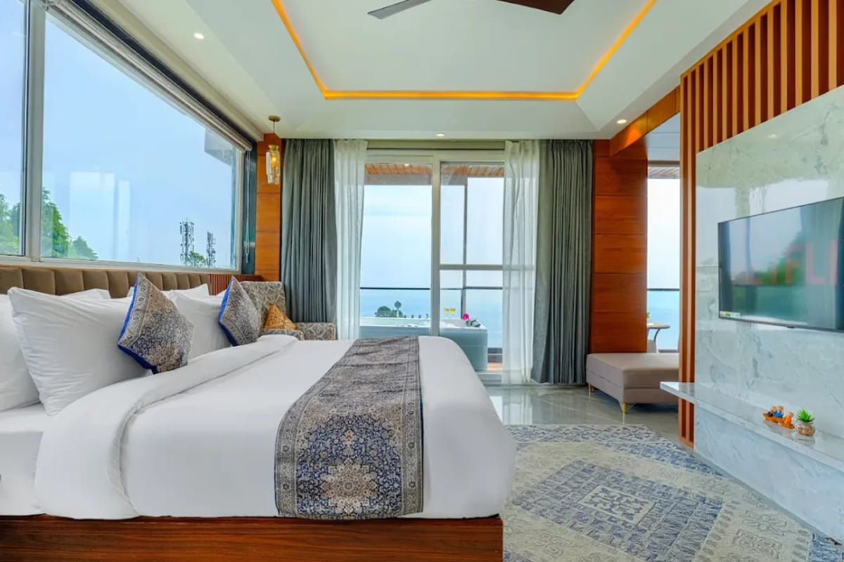 The Family Suite with Mountain View at White Panda Hotel Divine Peaks, with a wide window over the valley, a patterned rug