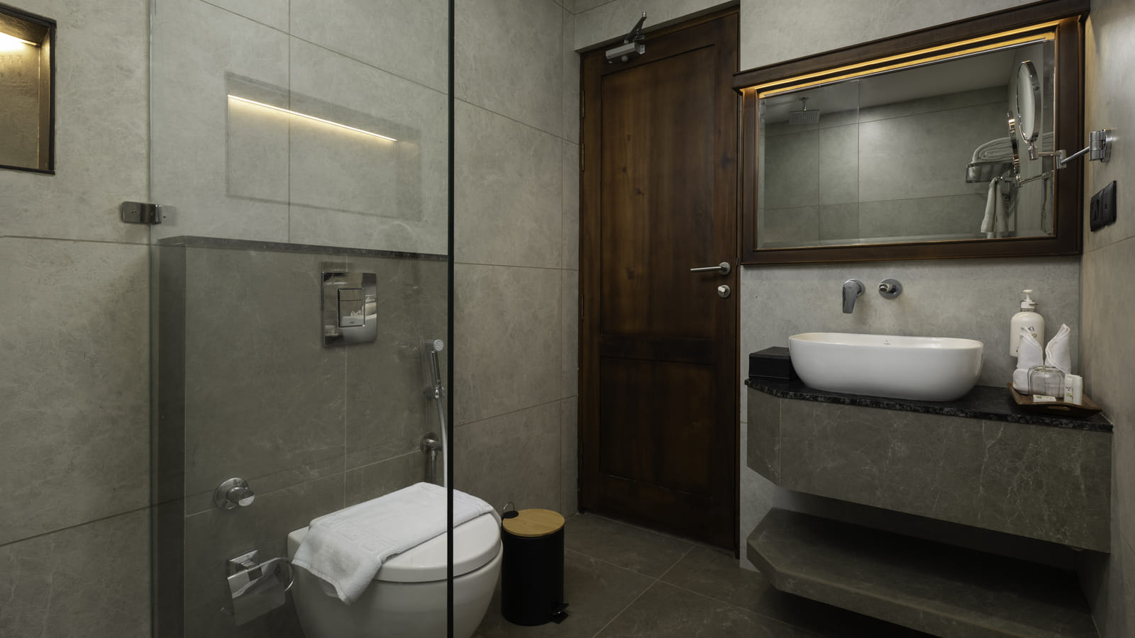 Lake View Room bathroom with a stone-tiled shower cubicle, wooden vanity and framed mirror, Sanskreti