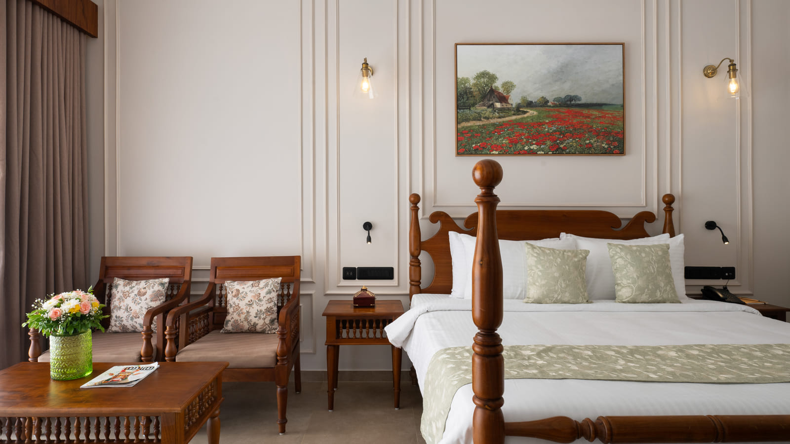 Pool View Room with king bed on the left and a cushioned armchair and side table by the window, Sanskreti