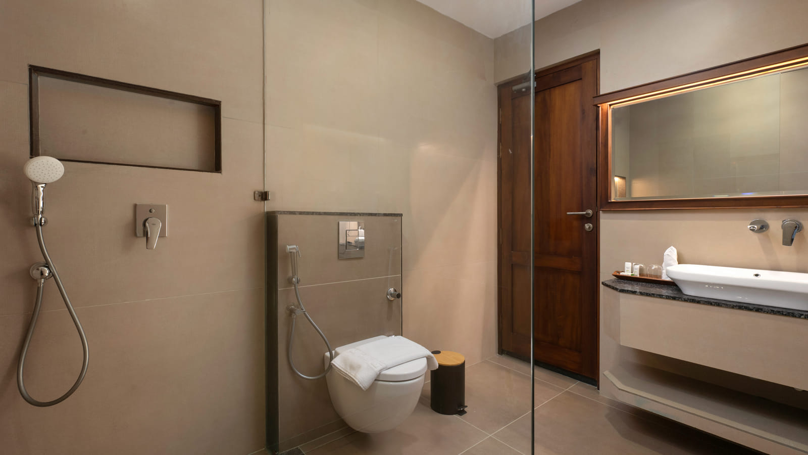 Pool View Twin Room bathroom with a stone-tiled shower cubicle, wooden vanity and framed mirror, Sanskreti