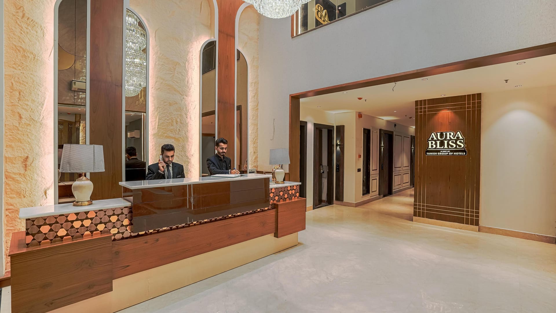 The reception at Aura Bliss, with two members of staff at the timber desk