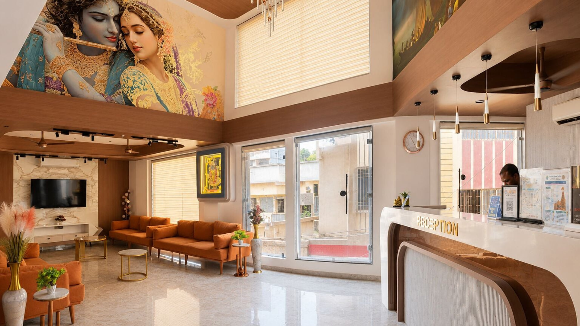 The reception at Hotel Shree Radhe By White Panda, with a member of staff at the curved counter