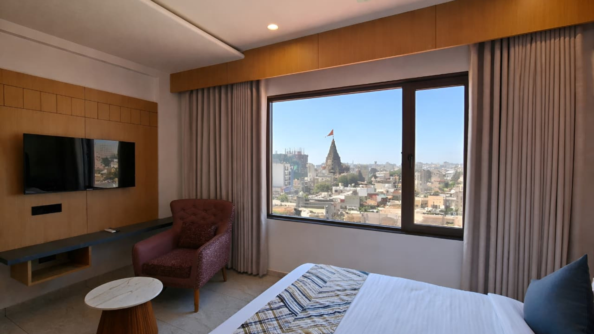 A Temple and Sea View room at Hotel Shree Radhe By White Panda, with a temple spire visible over the rooftops