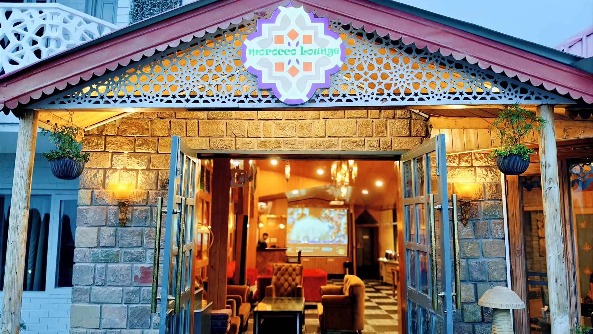 The stone-fronted restaurant and bar building at Levelup The Heritage Kud, its pitched roof and signage above the glass doors