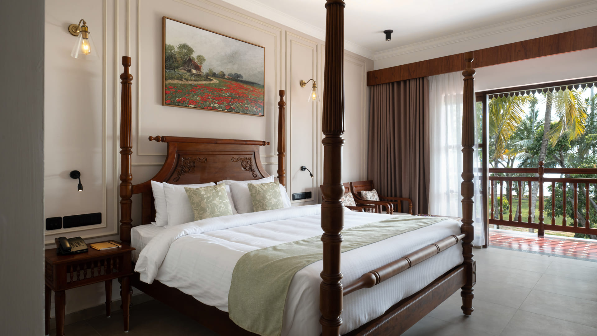 Lake View Room with a four-poster king bed, red-and-cream chequered runner and balcony doors framing palms and Vembanad Lake, Sanskreti