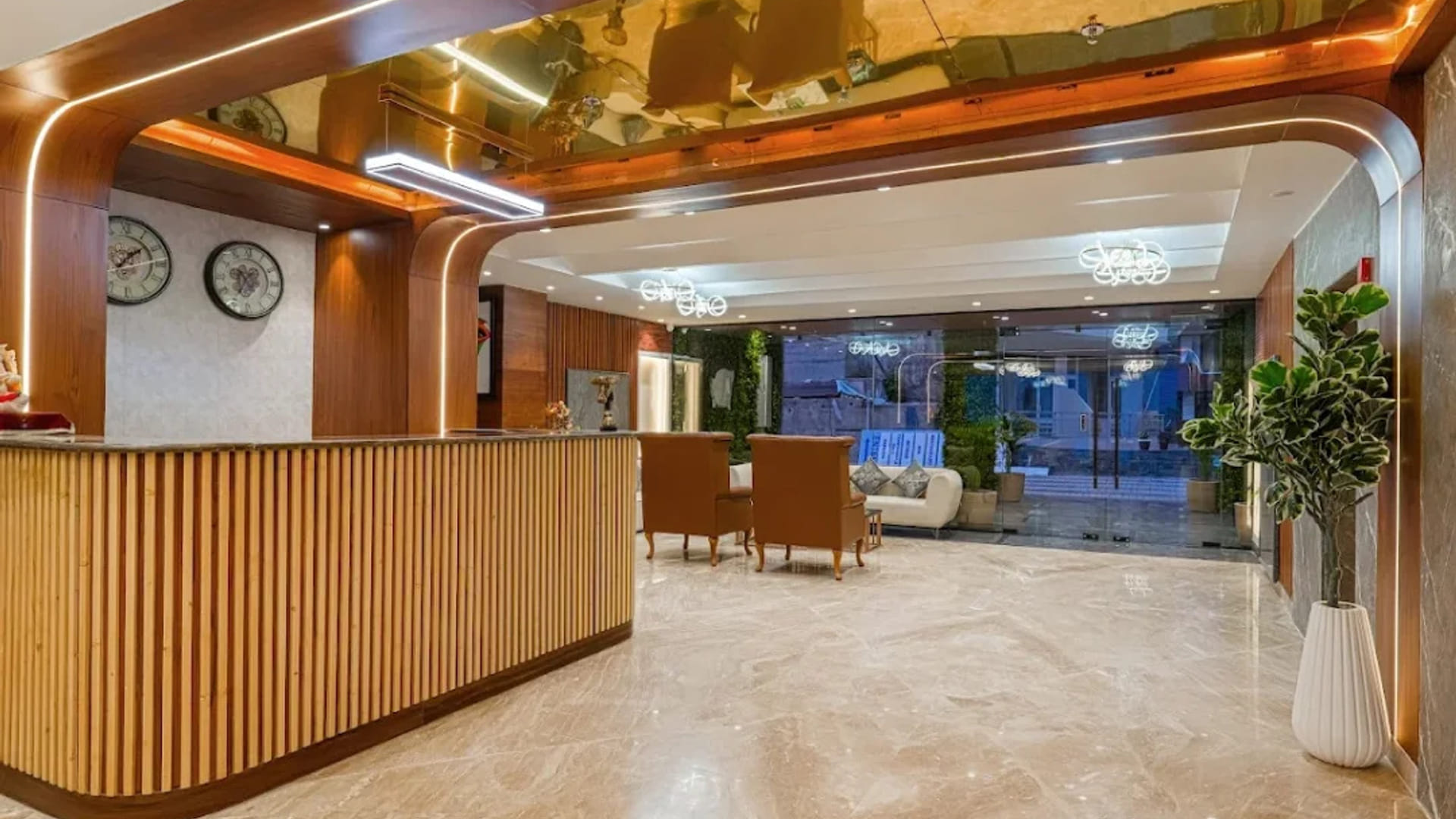 The reception at White Panda Hotel Divine Peaks, with a curved timber counter, a row of wall clocks above it