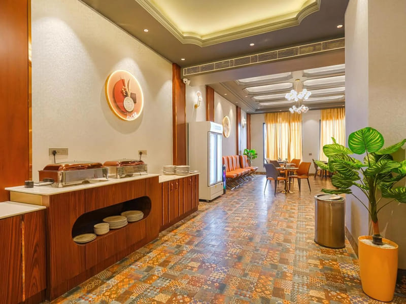 The breakfast buffet counter at Marrion Hotel, with chafing dishes along the wood-panelled counter, stacked plates