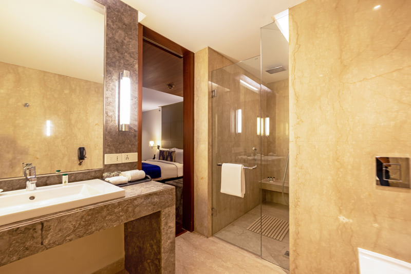 Luxury Suite bathroom with walk-in shower at The Anya Hotel, Gurugram