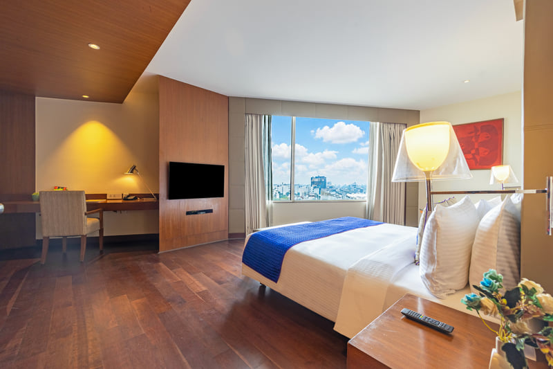 Luxury Suite bedroom with work desk at The Anya Hotel, Gurugram