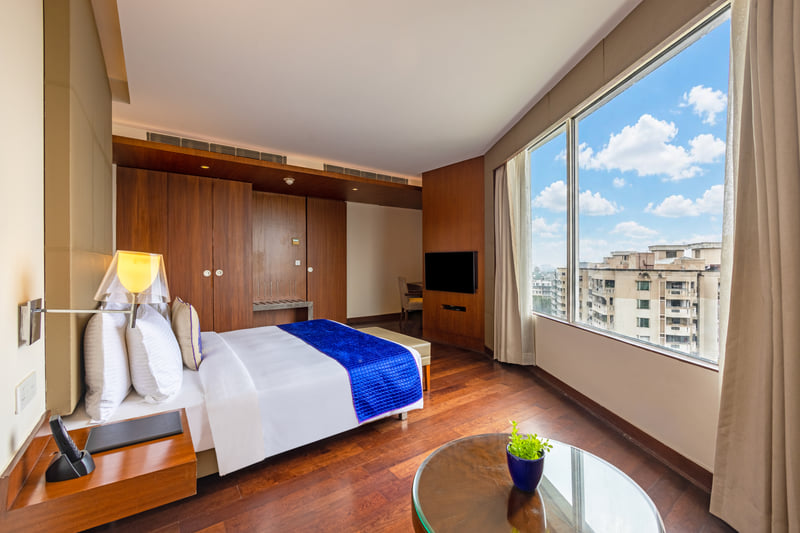 Luxury Suite bedroom with city view at The Anya Hotel, Gurugram